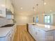 Large kitchen area featuring stainless steel appliances, white cabinets, and a tiled backsplash at 123 Armstrong Rd, Belmont, NC 28012