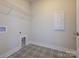 Neat and clean laundry room with decorative flooring and wire shelving at 123 Armstrong Rd, Belmont, NC 28012