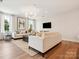 Elegant living room with modern lighting, plush sofas, and hardwood floors at 123 Armstrong Rd, Belmont, NC 28012