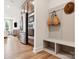 Mudroom featuring a bench and coat rack near stainless steel kitchen appliances and living area at 123 Armstrong Rd, Belmont, NC 28012