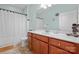 Well-lit bathroom with a wood vanity, white countertops, and shower and tub combination at 137 Leaning Tower Dr, Mooresville, NC 28117