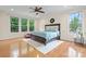 Bright and airy bedroom featuring hardwood floors, a ceiling fan, and large windows at 137 Leaning Tower Dr, Mooresville, NC 28117