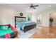 A beautifully staged bedroom with a queen bed, wood floors, and ample natural light from the window at 137 Leaning Tower Dr, Mooresville, NC 28117