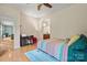 This bedroom features a quaint desk setup and access to a bathroom, providing convenience and functionality at 137 Leaning Tower Dr, Mooresville, NC 28117