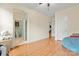 Large bonus room with light walls, wood floors, and multiple doors leading to other rooms and bathrooms at 137 Leaning Tower Dr, Mooresville, NC 28117