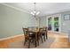 A dining room features a table with seating for six and has French doors to the outside deck at 137 Leaning Tower Dr, Mooresville, NC 28117