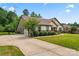 A beautiful home featuring an attached two-car garage with a basketball hoop, complemented by mature trees at 137 Leaning Tower Dr, Mooresville, NC 28117