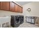 Functional laundry room with plenty of cabinet space, a utility sink, and modern washer and dryer at 137 Leaning Tower Dr, Mooresville, NC 28117