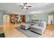 Bright living room features hardwood floors, a modern sofa, and lots of natural light from the windows at 137 Leaning Tower Dr, Mooresville, NC 28117