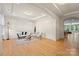 Spacious living room with hardwood floors, tray ceilings, and an open layout to the kitchen at 137 Leaning Tower Dr, Mooresville, NC 28117