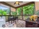 Inviting screened porch with a dining set, outdoor furniture, and picturesque views of the lush yard at 137 Leaning Tower Dr, Mooresville, NC 28117