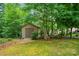 Backyard shed nestled among lush greenery, providing practical storage and blending seamlessly with the landscape at 137 Leaning Tower Dr, Mooresville, NC 28117