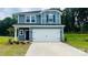 Two story home with blue siding, white trim, dark blue door and two car garage at 141 Satchel Ct, Mooresville, NC 28115