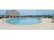 Community pool with lounge chairs and umbrellas for residents at 1413 Old Rivers Rd, Concord, NC 28027