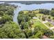 Aerial view of a waterfront property surrounded by lush greenery and serene lake waters at 145 Waterwood Dr, Shelby, NC 28150