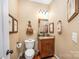 Cozy powder room with a unique mirror, stylish fixtures, and warm, inviting decor at 145 Waterwood Dr, Shelby, NC 28150
