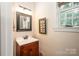 Bathroom with vanity, framed mirror, and a window with natural lighting at 145 Waterwood Dr, Shelby, NC 28150