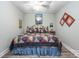Bedroom with carpeted floors, a ceiling fan, a bed with patterned quilt, and decorated walls at 145 Waterwood Dr, Shelby, NC 28150
