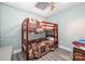 Bedroom with a wooden bunk bed, gray floors, and muted green-blue walls at 145 Waterwood Dr, Shelby, NC 28150
