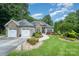 Charming exterior with stone accents, manicured landscaping, and a three-car garage at 145 Waterwood Dr, Shelby, NC 28150