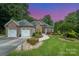 Charming exterior with stone accents, manicured landscaping, and a three-car garage at 145 Waterwood Dr, Shelby, NC 28150