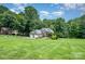 Well-maintained lawn and landscaping with a three car garage at 145 Waterwood Dr, Shelby, NC 28150