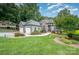 Beautiful landscaped front yard featuring a two-car garage and stone accents on the charming home at 145 Waterwood Dr, Shelby, NC 28150