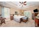 Spacious primary bedroom with tray ceilings, french doors, and neutral decor at 145 Waterwood Dr, Shelby, NC 28150