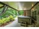 Backyard patio with a relaxing hot tub and serene wooded backdrop at 145 Waterwood Dr, Shelby, NC 28150
