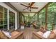 Spacious screened porch with multiple seating areas, ceiling fans, and wooded views at 145 Waterwood Dr, Shelby, NC 28150