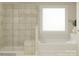 Modern bathroom featuring a separate shower and tub, complemented by bright natural light through a window at 1569 Croydon St, Indian Land, SC 29707
