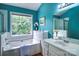 Inviting bathroom featuring blue walls, tub, shower, and large window with backyard view at 1633 Kiawah Ct, Gastonia, NC 28056
