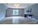 A bonus room with wood flooring and light gray walls, lit by one large window at 1633 Kiawah Ct, Gastonia, NC 28056