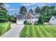 Charming two-story home with a well-manicured lawn, a red front door, and lush landscaping at 1633 Kiawah Ct, Gastonia, NC 28056