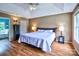 Comfortable bedroom with tray ceiling, hardwood floor, bedside tables, and natural light at 1633 Kiawah Ct, Gastonia, NC 28056