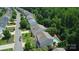 An aerial view of a quiet neighborhood street lined with single-Gathering homes and lush greenery at 1673 Beleek Ridge Ln, Clover, SC 29710