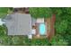 An aerial view of a backyard with a deck, an inground pool, patio space, and lots of greenery at 1673 Beleek Ridge Ln, Clover, SC 29710