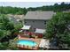 Backyard featuring a pool, deck, lounge area and mature trees around the home at 1673 Beleek Ridge Ln, Clover, SC 29710