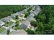 Aerial view of homes, green trees, a neighborhood street and a private backyard pool at 1673 Beleek Ridge Ln, Clover, SC 29710