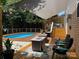 Private backyard pool, patio seating, and lush green landscaping at 1673 Beleek Ridge Ln, Clover, SC 29710