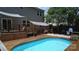 Backyard view of a pool, deck, and outdoor seating area with mature trees at 1673 Beleek Ridge Ln, Clover, SC 29710
