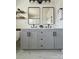Modern bathroom with double vanity, black hardware, floating shelves, and marble-look tile at 1673 Beleek Ridge Ln, Clover, SC 29710