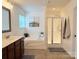 Bathroom with a soaking tub, walk-in shower, a decorative mirror, and a neutral-colored tile floor at 1673 Beleek Ridge Ln, Clover, SC 29710