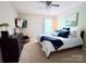 Cozy bedroom features a comfortable bed, modern ceiling fan, and a mounted television for relaxing evenings at 1673 Beleek Ridge Ln, Clover, SC 29710