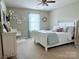 A well-lit bedroom featuring neutral walls, a ceiling fan, a window, and a neatly made white bed at 1673 Beleek Ridge Ln, Clover, SC 29710
