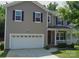 Charming two-story home with a welcoming front porch and well-maintained lawn at 1673 Beleek Ridge Ln, Clover, SC 29710
