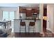 Modern kitchen with stainless steel appliances, dark cabinetry, breakfast bar, and seating at 1673 Beleek Ridge Ln, Clover, SC 29710