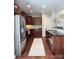 Modern kitchen with stainless steel appliances, dark wood cabinets, and tile backsplash at 1673 Beleek Ridge Ln, Clover, SC 29710