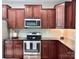 Kitchen featuring dark wood cabinets, stainless steel appliances, and granite countertops at 1673 Beleek Ridge Ln, Clover, SC 29710