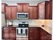 Updated kitchen with stainless steel appliances, tiled backsplash, and dark cabinets at 1673 Beleek Ridge Ln, Clover, SC 29710